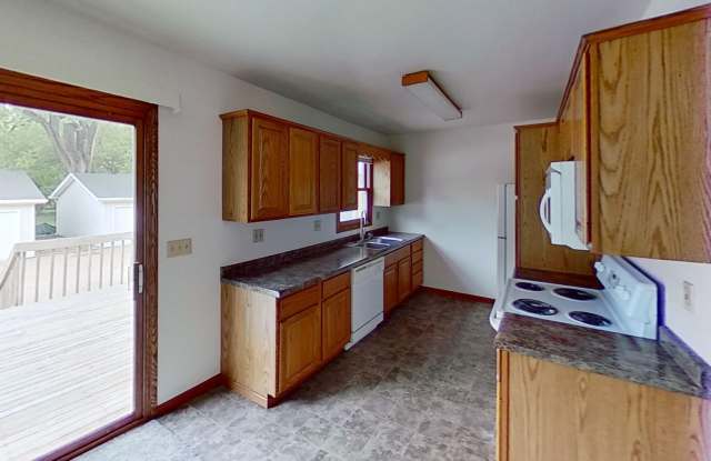 Huge 24' x 28' garage, two story duplex with two large bedrooms, one and a half bath, full basement, 12x18 deck, lawn and snow provided.