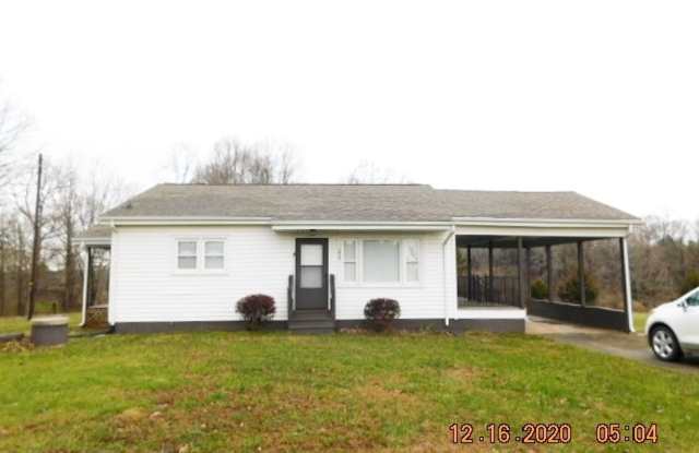Home with 2 bedrooms, 1 bath, side deck, carport with side porch and detached garage