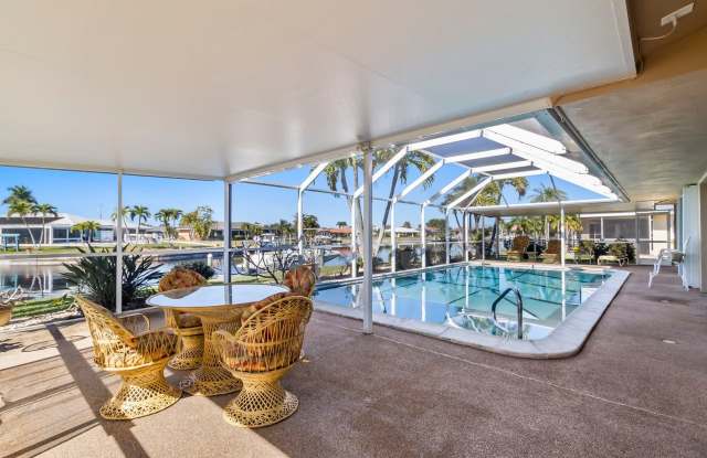 PGI Canal Home ** AVAILABLE 4/15/24 - FURNISHED - Annual / Short Term -- 2 Bed / 2 Bath + Den - - Heated Pool Home - 3019 Guadalupe Drive, Punta Gorda, FL 33950