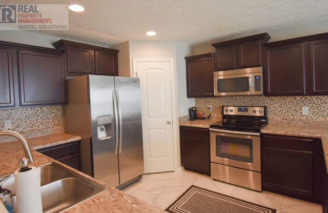 Gorgeous townhome w/2 car garage, triple Blackman schools, neighborhood pool!