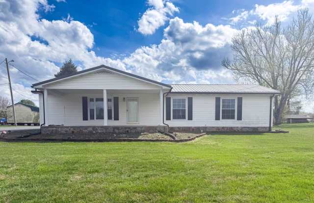 Spacious 3-Bedroom Home with Huge Yard, Covered Porches & Storage Building