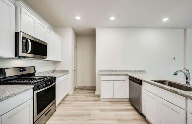 This beautifully designed, two-story townhome is located in South Park Meadows