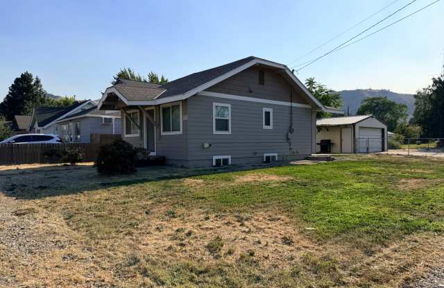 Spacious 2 bed/1 bath home! Fenced yard, a/c, d/w, w/d, large garage and MORE!!