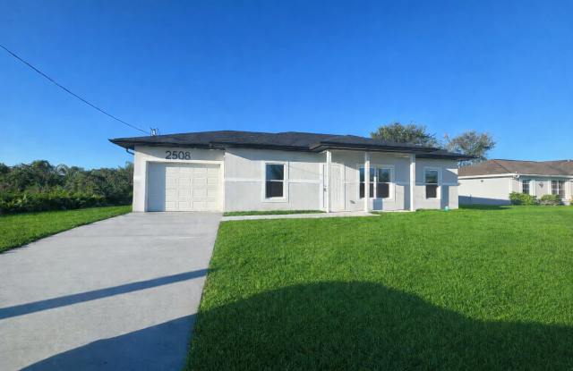 STUNNING NEW 3BR/2BA HOME WITH GARAGE -IN PRIME SW LEHIGH ACRES LOCATION
