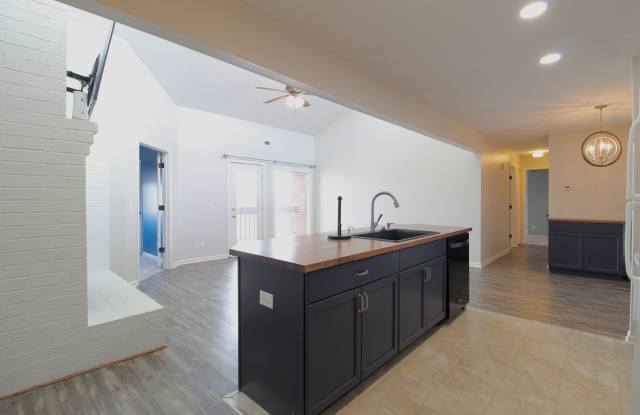 Top floor completely remodeled condo with open concept, vaulted ceilings and an electric fireplace!
