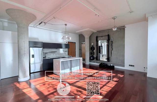 Sunny loft with in unit gym, heated floors in bathroom, contemporary kitchen, and includes water/garbage/1parking!