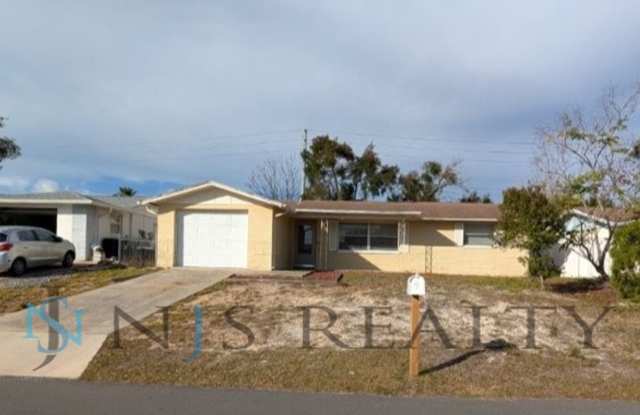 JUST REDUCED!!! Large 2/2/1 1060 sq ft home with INDOOR LAUNDRY, a full garage, updated kitchen and a fenced in yard!!