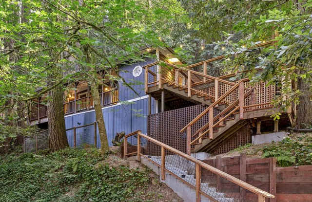 Fully furnished hillside 2 bedroom., 2 bath home among Redwood and Pine Trees, large covered porch, modern interior, deck