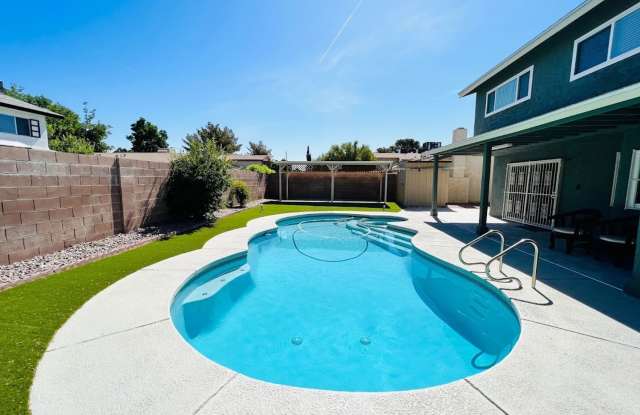 Gorgeous 4 Bed 2.5 Bath in a prime location! Home is over 2200 Sq Ft with a pool on a huge lot! Separate living room, dining room, and family room! Beautiful kitchen with stainless steel appliances built into the white cabinets!
