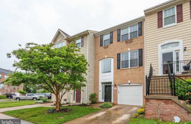 Spacious and sun filled townhome with a one car garage in the sought after Belmont Bay community.