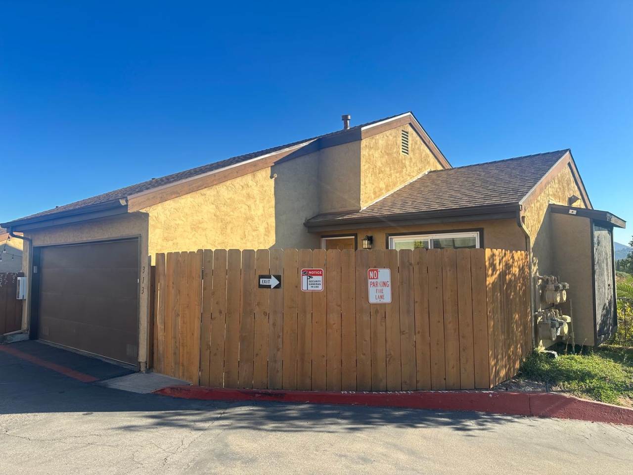 2BR/1.5BA 2-story condo in El Cajon, gated community with sparkling pool, 2 car attached garage, private backyard, balcony with a view, and more.