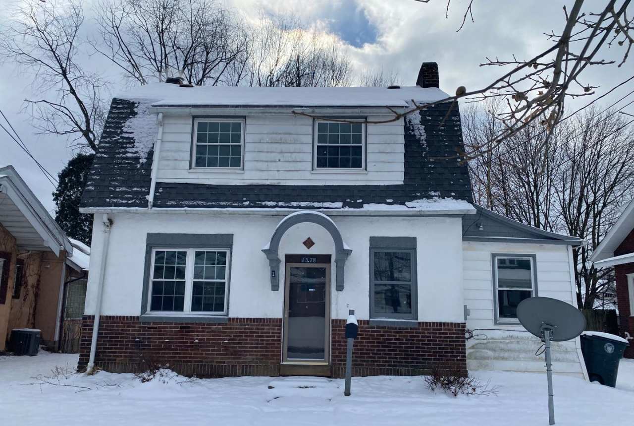 Cozy Akron Home w/ Fireplace Charm, Detached Garage  Back Porch