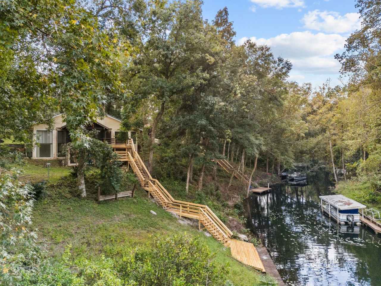 Beautifully updated 3-bedroom, 2-bathroom home situated on Lake Asbury, complete with a private dock, boat slip, and resident-only access to the Lake Asbury boat ramp