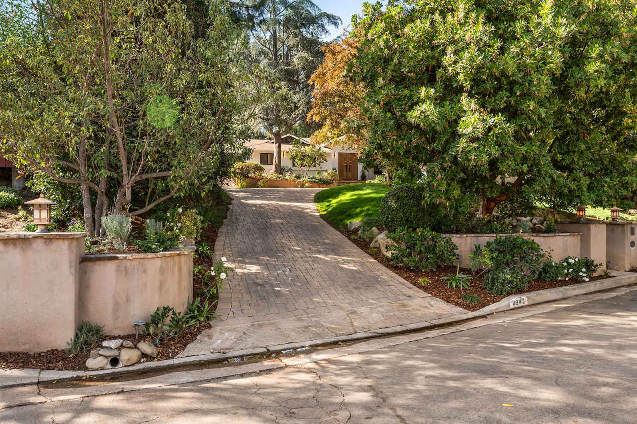Custom-built, single-story classic sits on close to half a wooded acre