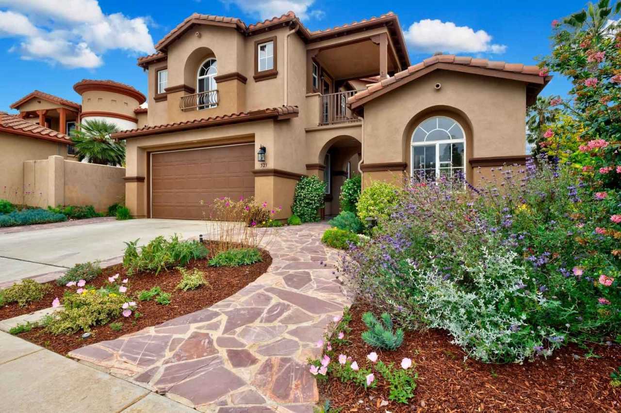 Gated corner lot home walking distance to the beach