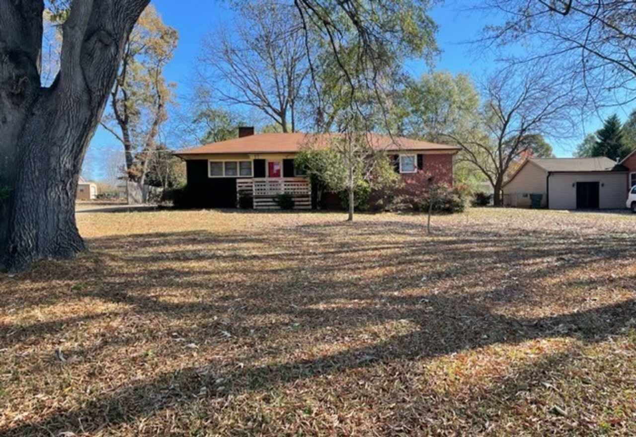 Adorable 3-bed 2-bath brick ranch, sitting on nearly a half acre lot, is located in Gastonia