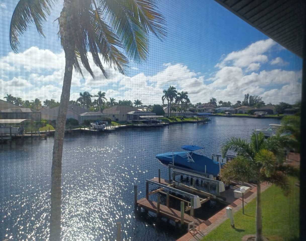 UPGRADED WATERFRONT END UNIT 3 BR / 2 BA Home With BOAT LIFT/ DOCK  OUTSTANDING VIEWS