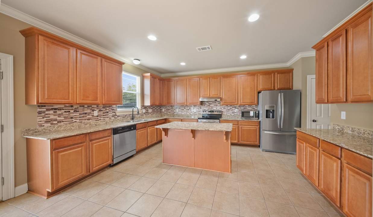 3 Bedroom home with a Bonus area! Sits on a Lake with a fenced yard!