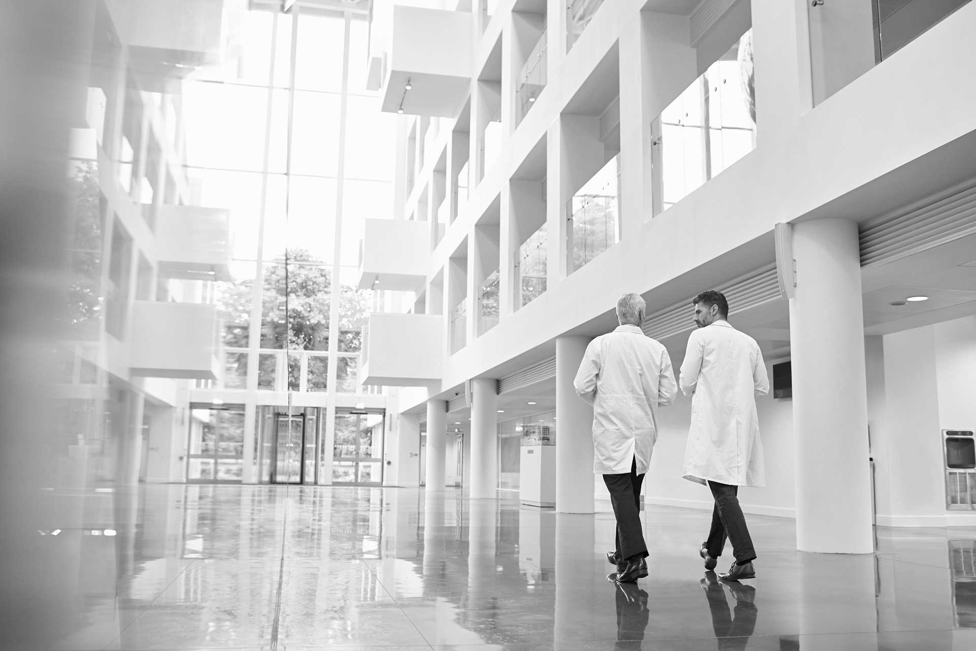 Two doctors walking together in a hospital.