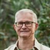 John Smith - Smiling man in his late sixties wearing glasses