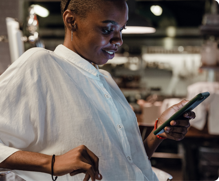Woman holding a phone while leaning back