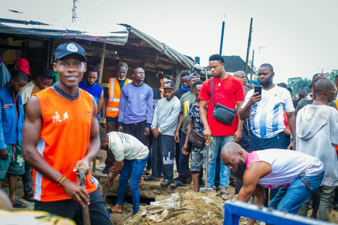 Residents clearing a blocked drain
