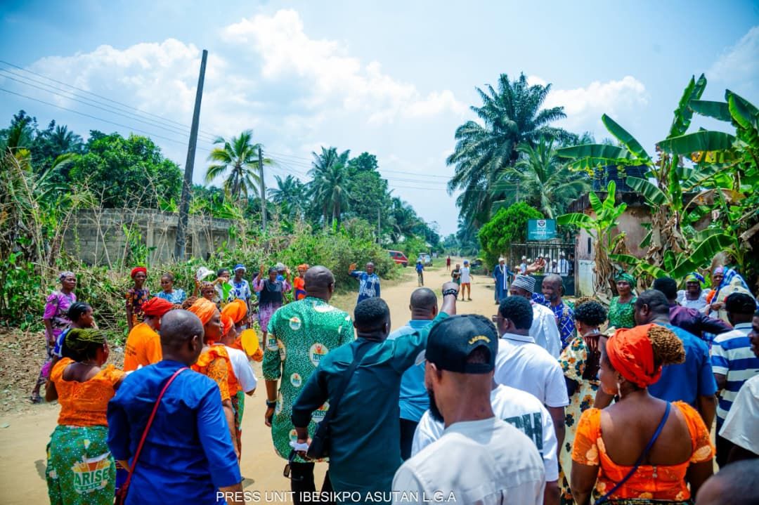Residents turn out along a graded road