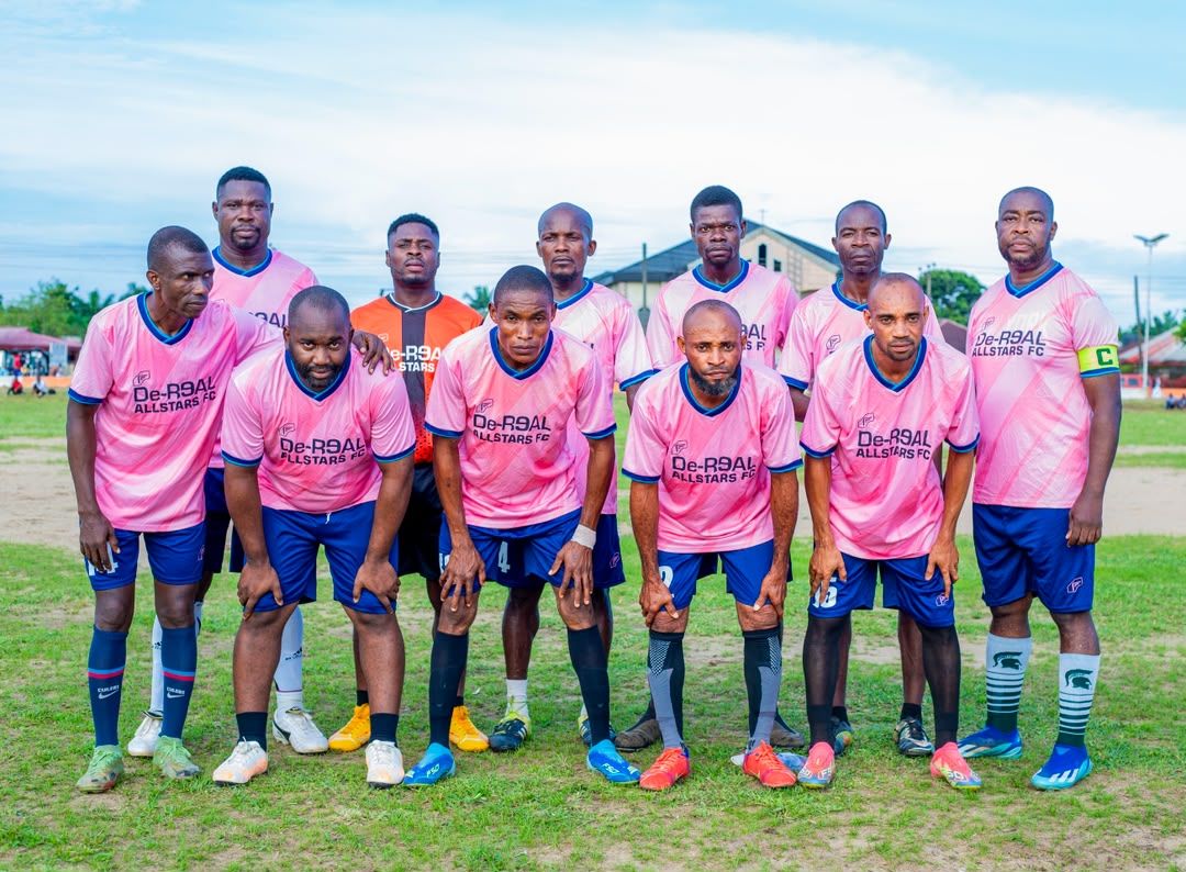 A team in pink kit poses for a group photo