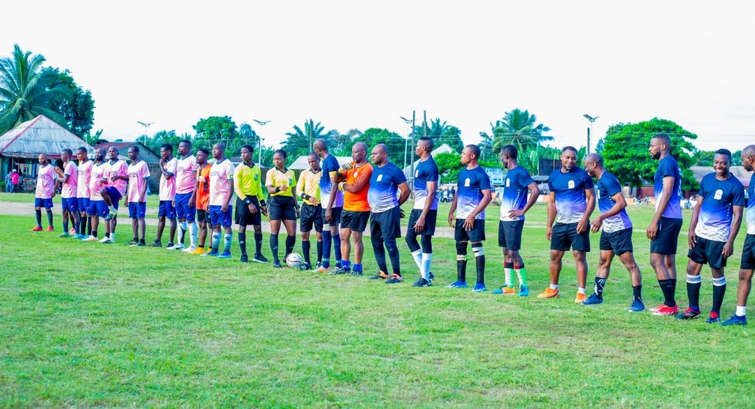 Players and officials in procession on the pitch