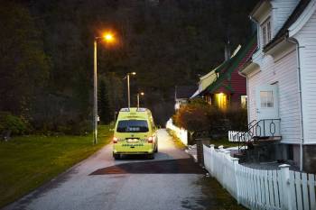 En ambulanse står parkert i en liten sidegate, den lyses opp av et gatelys. Foto: Øivind Haug