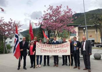 Nokre av personane som gjekk i tog, held parolen "sterkare fellesskap- enno betre saman"