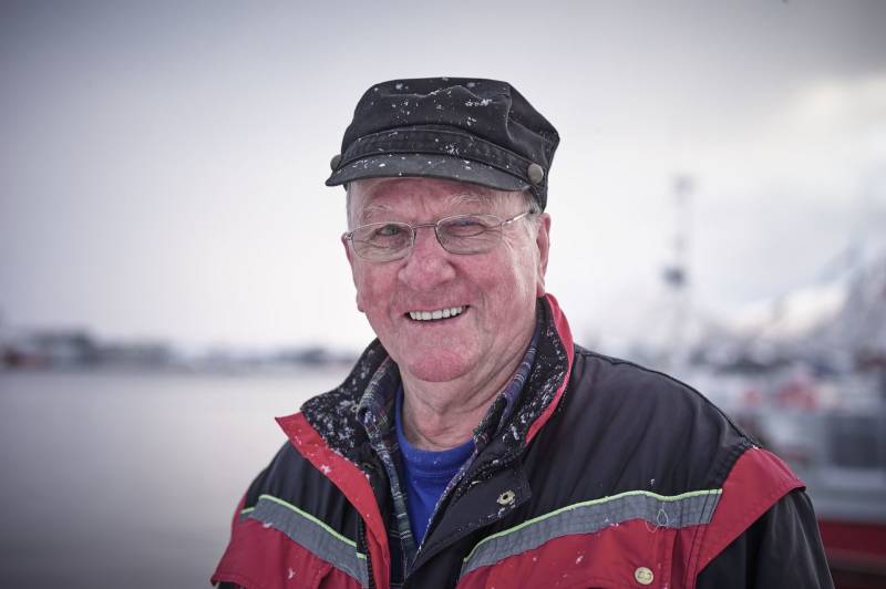En eldre mann står i arbeidsklær ved en havn. Foto: Øivind Haug