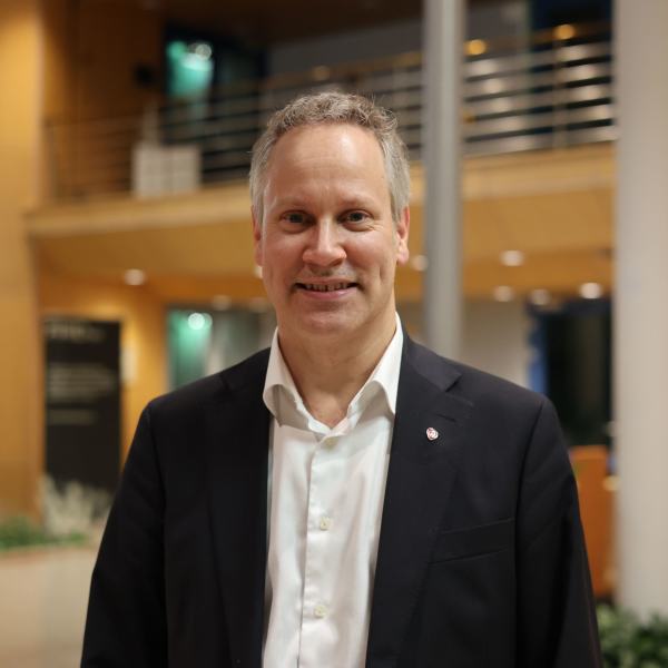 Jon-Ivar Nygård smilende i gangen i fylkeshuset.