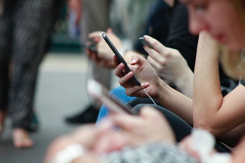 People Using mobile phones while traveling