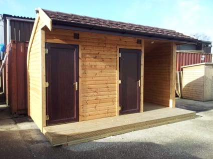 A half-arch shower block with two doors.