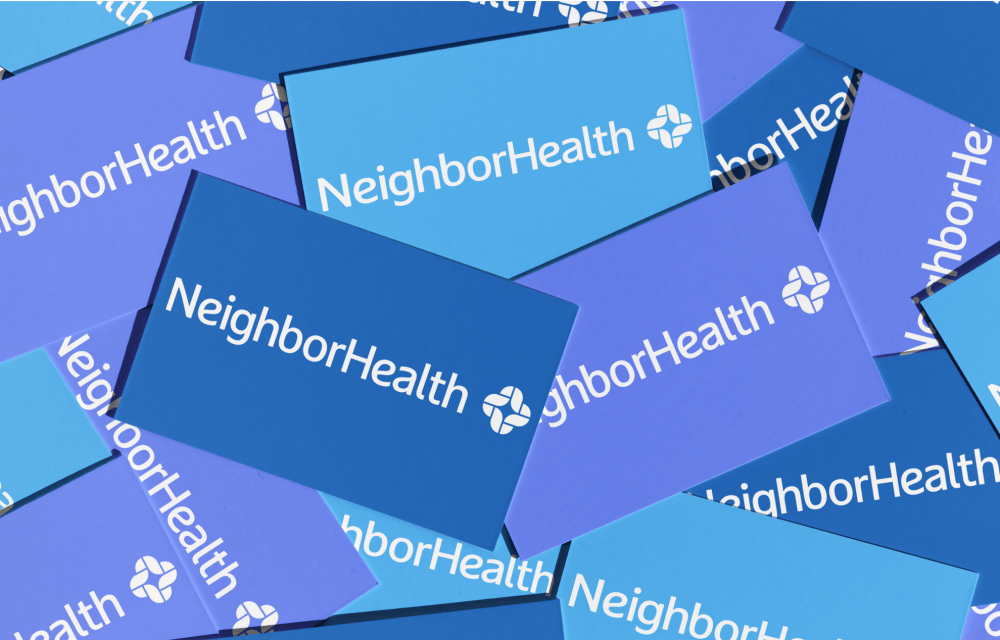 A pile of overlapping business cards displaying the "NeighborHealth" logo in white text on varying shades of blue backgrounds.