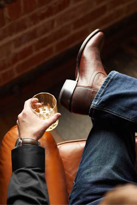 pair of premium leather boots sitting on a barrel