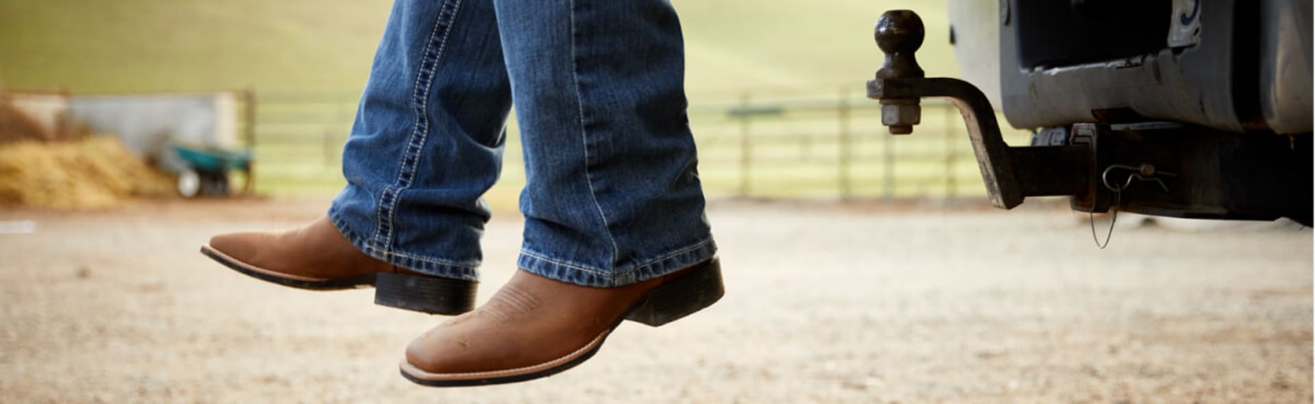 man cowboy boots sitting on truck