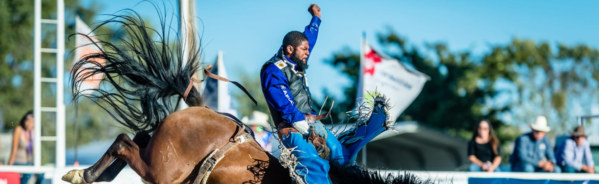 man riding horse at rodeo