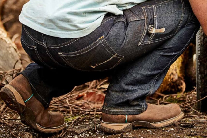 woman kneeling in work jeans