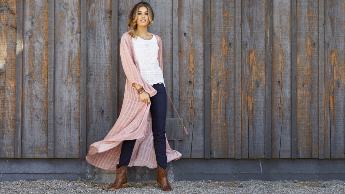 woman standing in front of wood wall