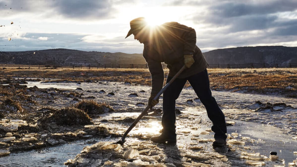 man doing ranch work in snow