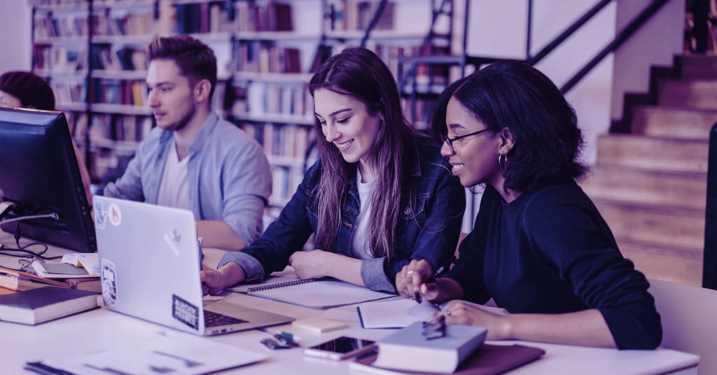 university students studying in a library