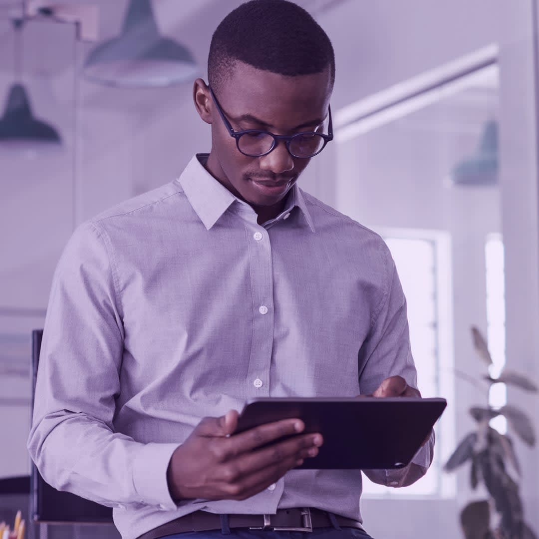 man looking at tablet in purple