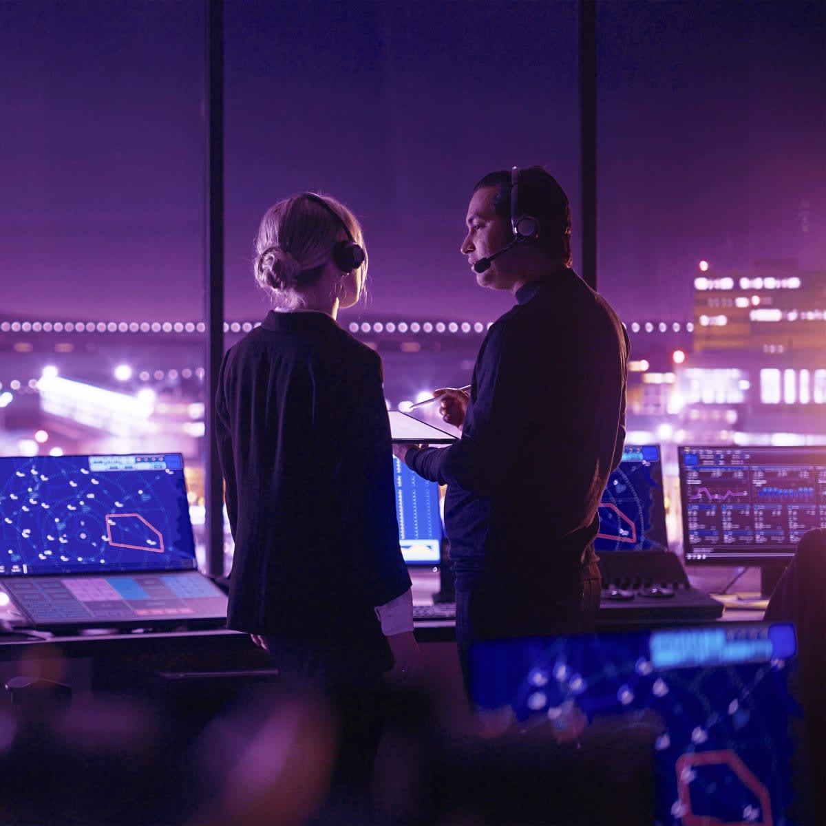 Air Traffic Control Team Working in Modern Airport Tower at Night