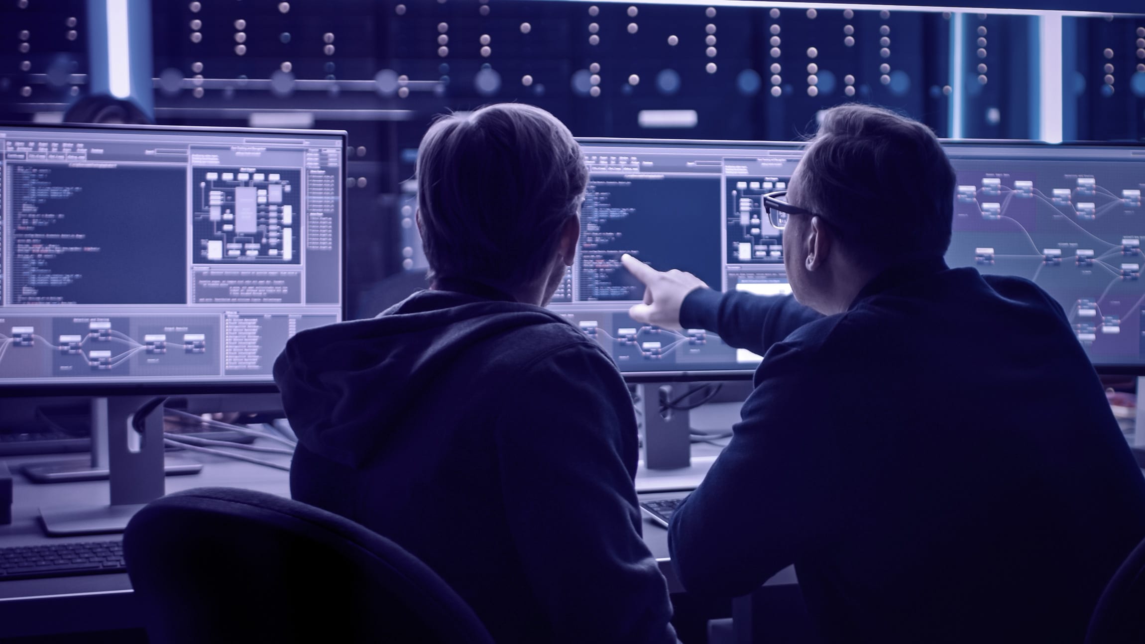 IT programers discussing blockchain data on desktop computer