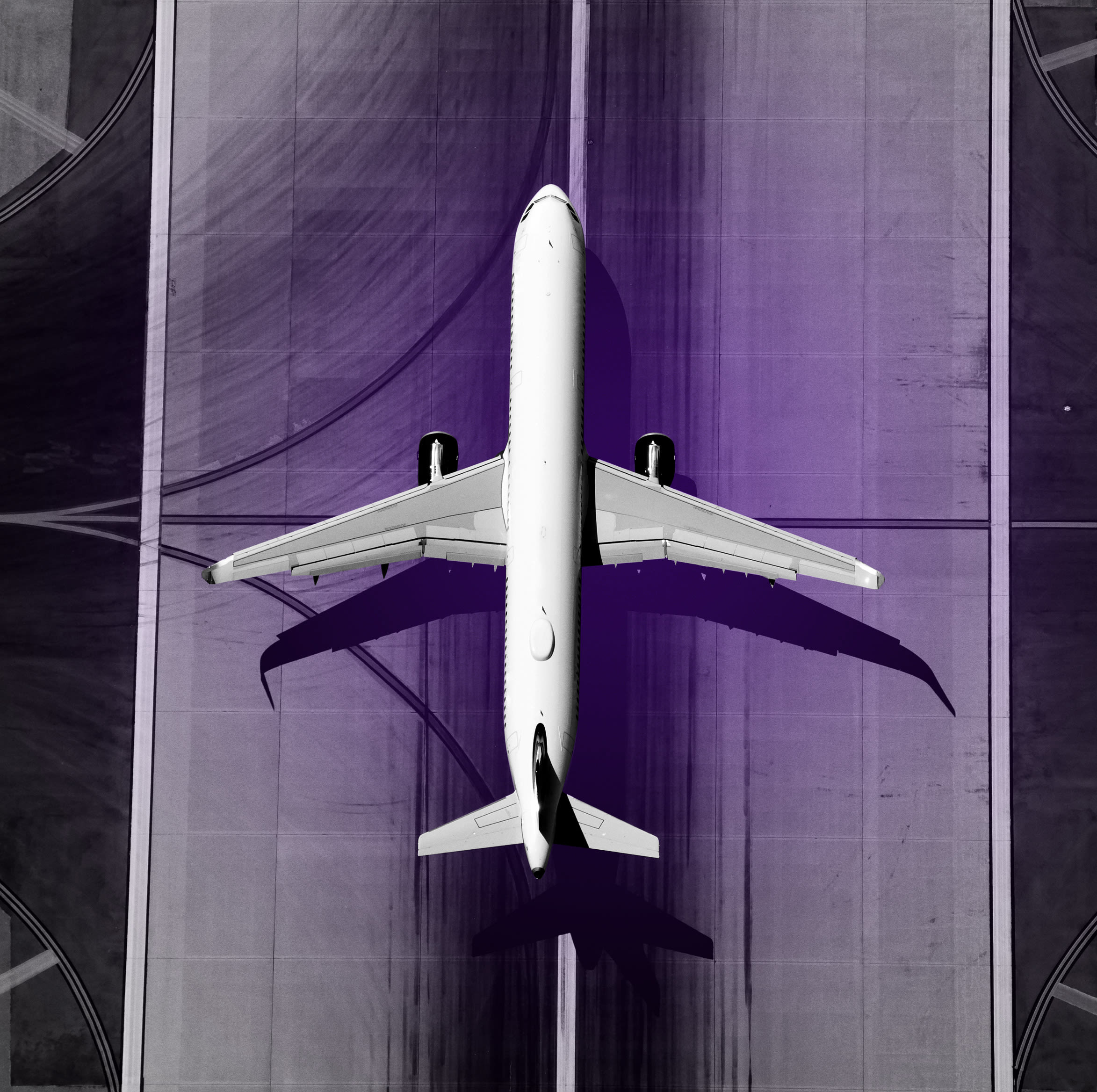 Aerial view of narrow body aircraft departing airport runway.