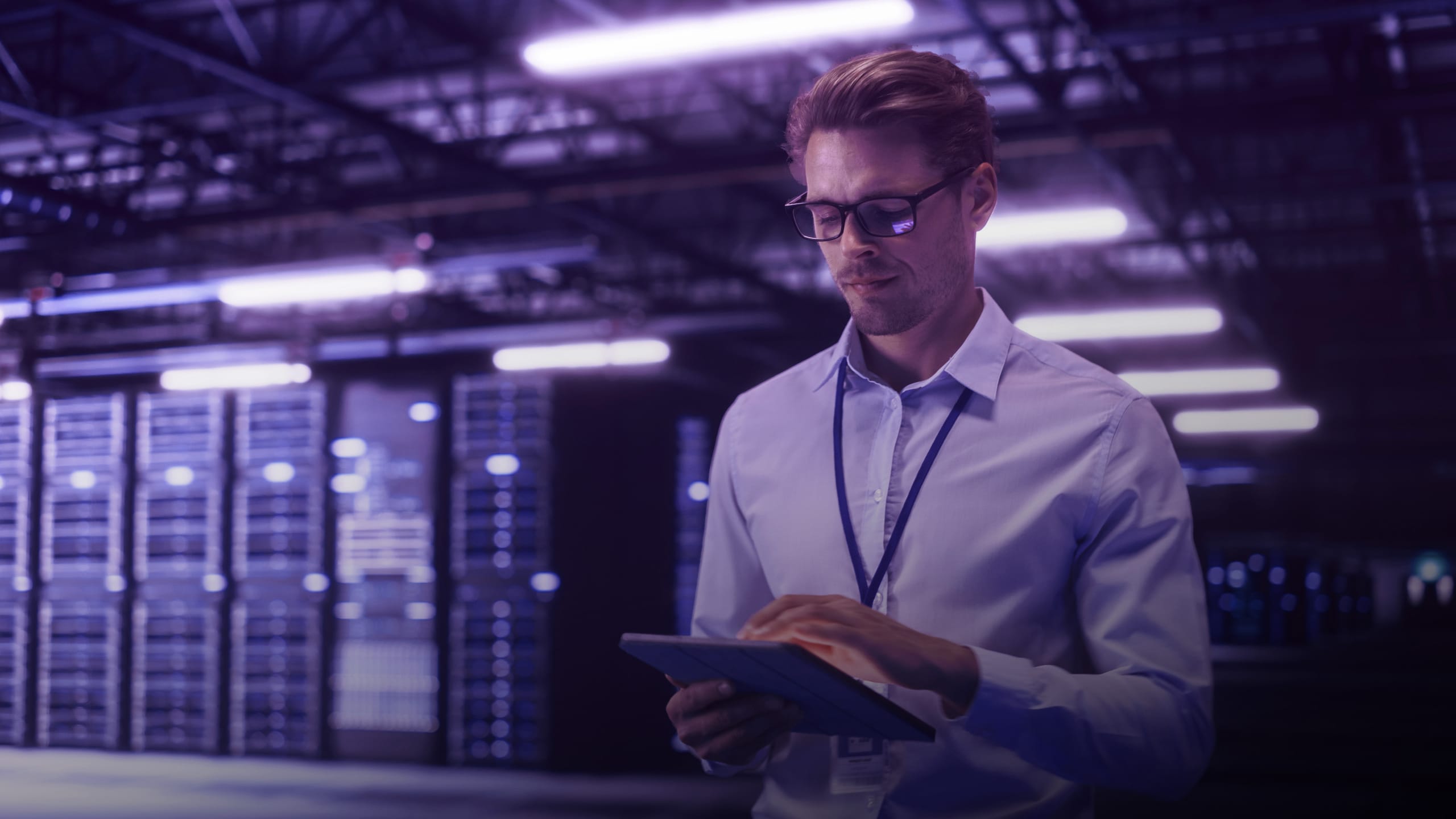 engineer working on laptop in a data center