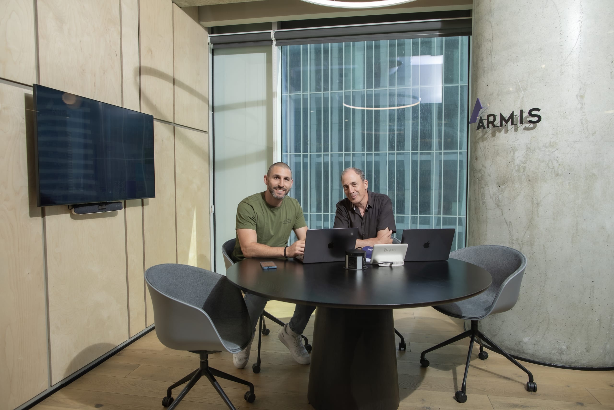 armis employees in a meeting in the conference room