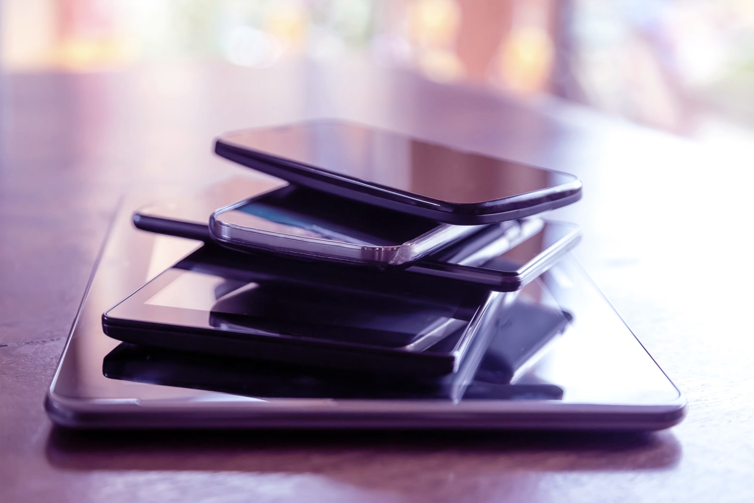 Stack of digital tablets and smartphones, close-up